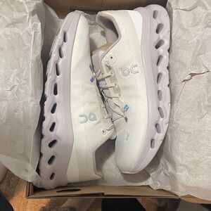 On Running Cream and Light Purple Sneakers